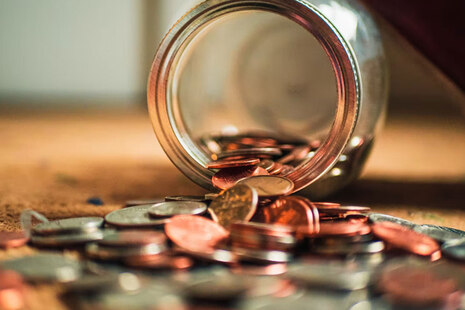 Jar of coins lying on a table