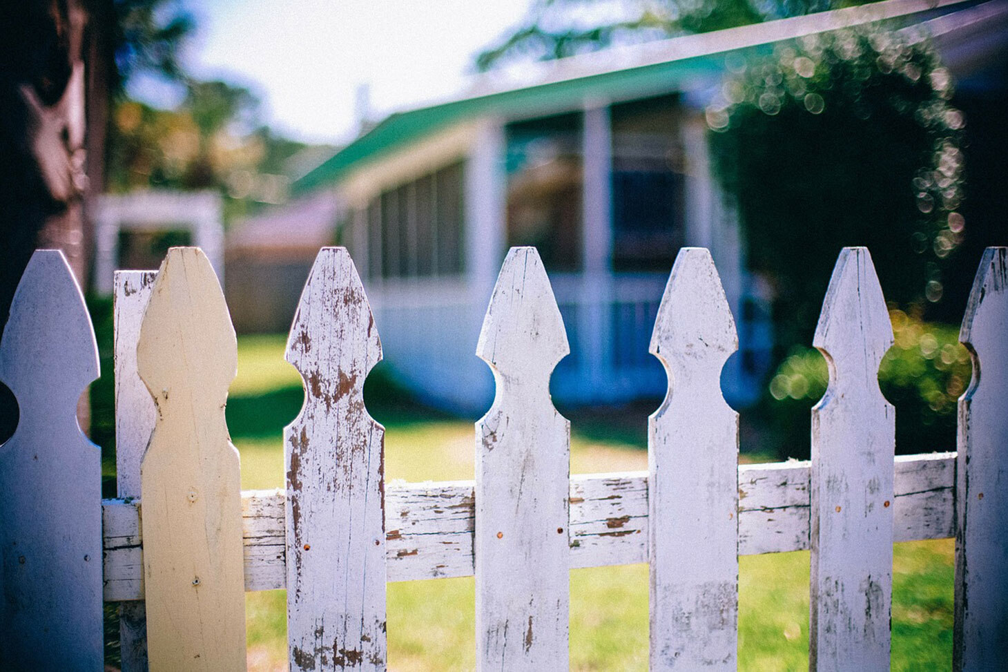 Garden fence in foreground, house in background